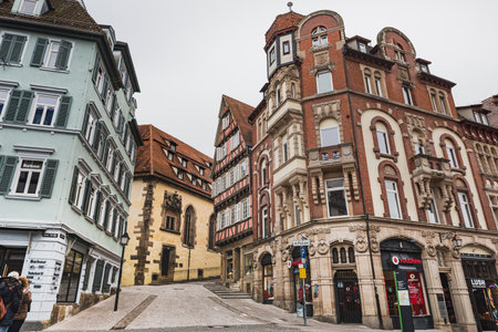 TÃ¼bingen, Germany - December 24, 2017

A neoclassical German building at a cobbled crossroad between Rathausgasse and Kornhausstrasse in the medieval old town of Tubingen with a Vodafone shopのeditorial素材