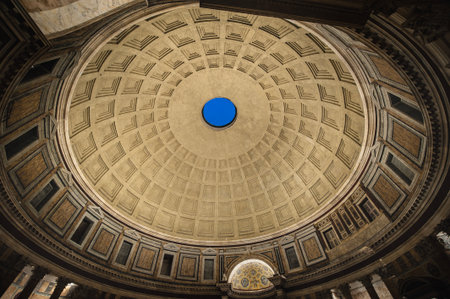 Detail of a decorated ceiling of a dome, example of Greek and Roman architecture. Closeup of an ancient dome with a hole in the middle and a pattern of squares inside a historical building. Old chapel inside of a Roman Doric peripteral temple. Rome, Italyの写真素材