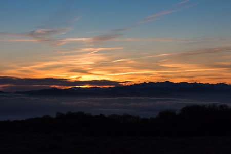 Sunset in the mountains with a carpet of cloudsの写真素材