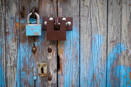 two different locks on old wooden garage door in Warsaw, Polandの写真素材