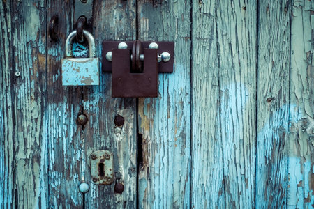 two different locks on old wooden garage door in Warsaw, Polandの写真素材