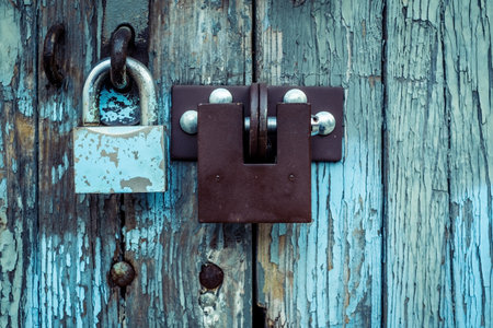 two different locks on old wooden garage door in Warsaw, Polandの写真素材