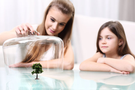 mother and daughter saving planetの写真素材