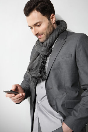 Young stylish man on a gray backgroundの写真素材
