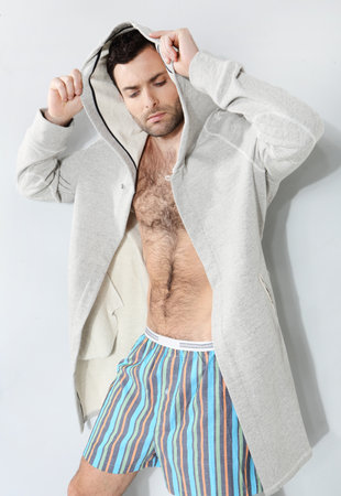 Stylish man in shorts on a gray backgroundの写真素材