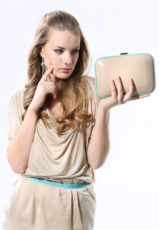 Beautiful girl with a white bag on a white backgroundの写真素材