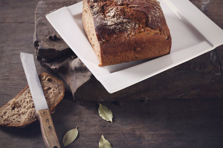 Knife with brown bread on a plate