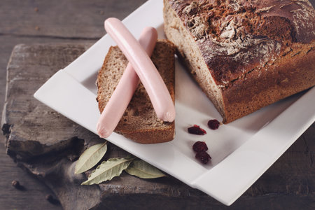 Black bread and sausage on a plateの写真素材