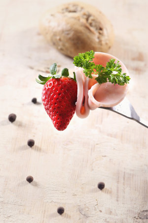 Strawberries and sausages, chop the plugの写真素材