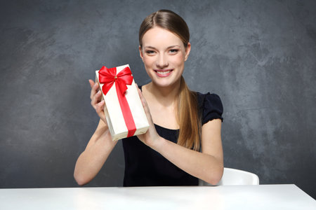 Girl holding a box with a giftの写真素材