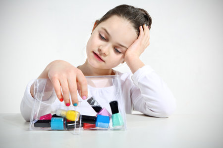 Little girl and nail polishesの写真素材