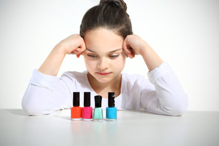 Little girl and nail polishes の写真素材