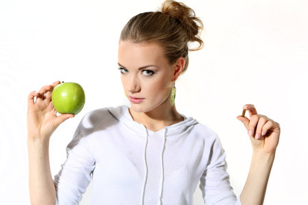 Girl with a green apple on a white backgroundの写真素材