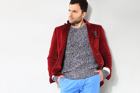Handsome man posing in a red jacketの写真素材