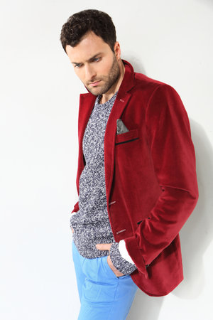 Handsome man posing in a red jacketの写真素材
