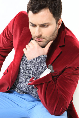 Handsome man posing in a red jacketの写真素材
