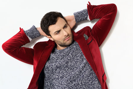 Handsome man posing in a red jacketの写真素材