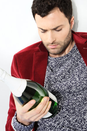 Portrait of male with a bottle of champagneの写真素材