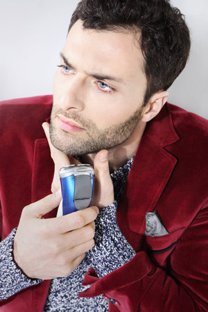 Portrait of male chin and electric shaveの写真素材