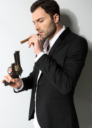 Man Holding a fire gun and smoking a cigarの写真素材