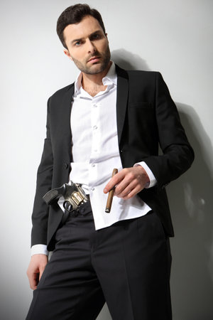 Man Holding a fire gun and smoking a cigarの写真素材