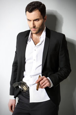 Man Holding a fire gun and smoking a cigarの写真素材