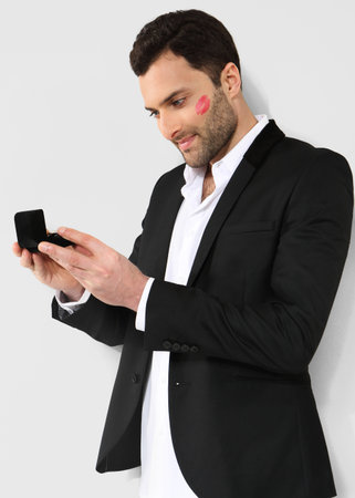 Attractive man looking at black box with cufflinksの写真素材
