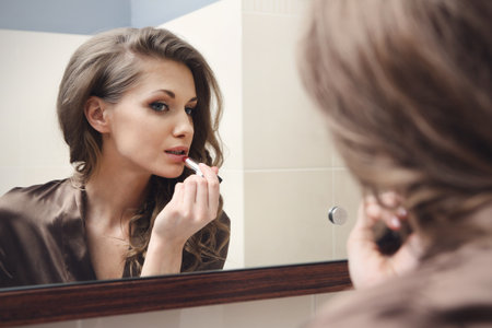 The young beautiful girl does makeupの写真素材
