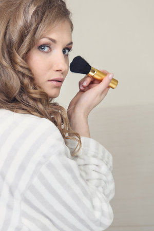 The young beautiful girl does makeupの写真素材