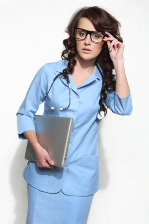 Woman doctor carrying a laptopの写真素材