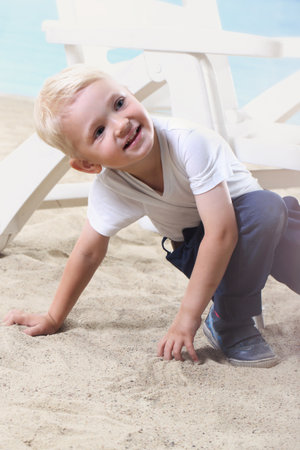 Beautiful little boy on the beachの写真素材
