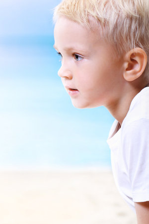 Beautiful little boy on the beachの写真素材