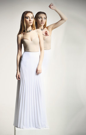 Portrait of beautiful young woman in white dressの写真素材