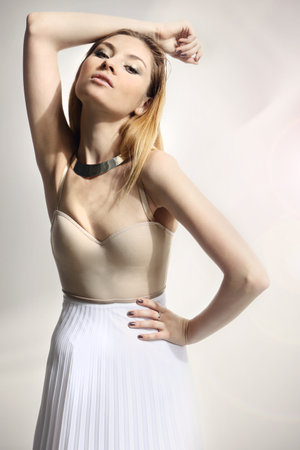 Portrait of beautiful young woman in white dressの写真素材