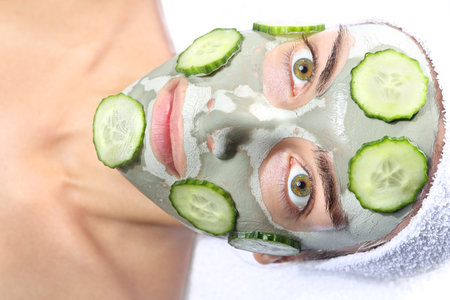 relaxes in the mask with green clay and cucumber の写真素材