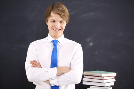 Happy student on the background of blackboard の写真素材