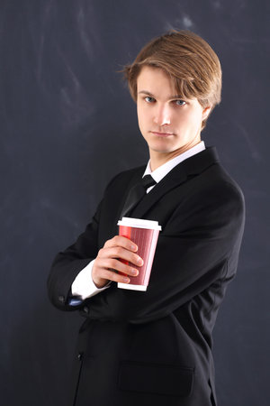 Boy in the jacket with a cup of coffee の写真素材