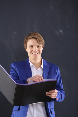 Smiling office worker with a file holderの写真素材