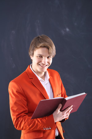 Smiling young teacher holding scoreboards の写真素材