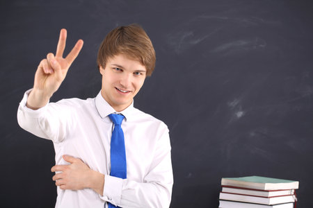 Male teacher showing 2 fingersの写真素材