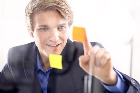 Businessman sticking notes の写真素材