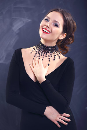 Attractive woman in a beautiful lace necklace on a black backgroundの写真素材