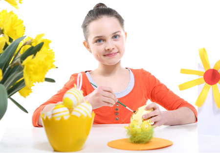 Girl decorates Easter eggsの写真素材
