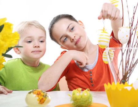 Family Easter- children decorates Easter eggs の写真素材