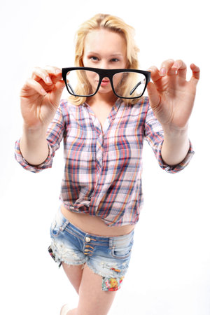Girl with glasses   Fashionable, sensual blonde girl in stylish glasses dressed in shirts and shortsの写真素材