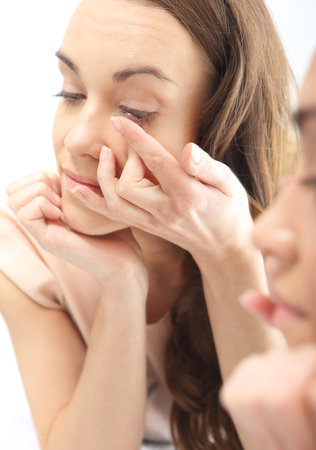 Woman found contact lenses の写真素材