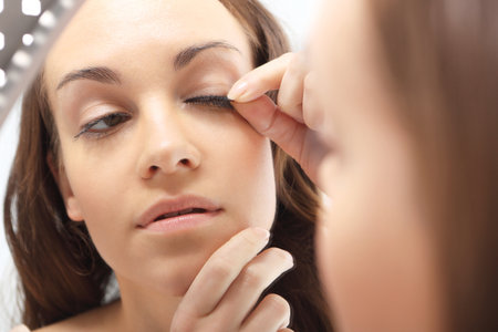 Plastics  eyelashes, flirty look   Woman stuck artificial long eyelashes の写真素材