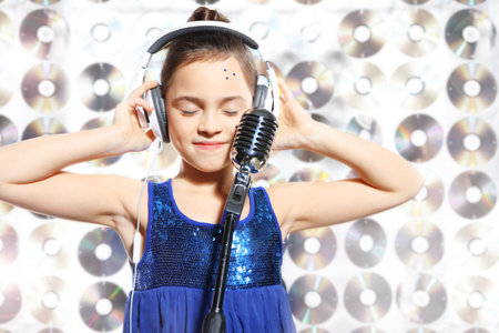 I love music  Child, teen, girl, singing into a microphone, a small singerの写真素材