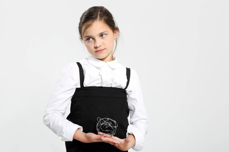 Little girl holding in her hand a bundle of barbed wire.の写真素材