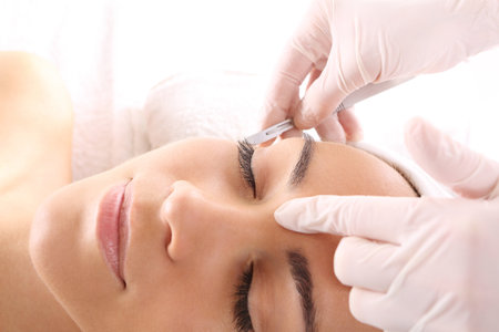 Caucasian woman during surgery using a scalpelの写真素材